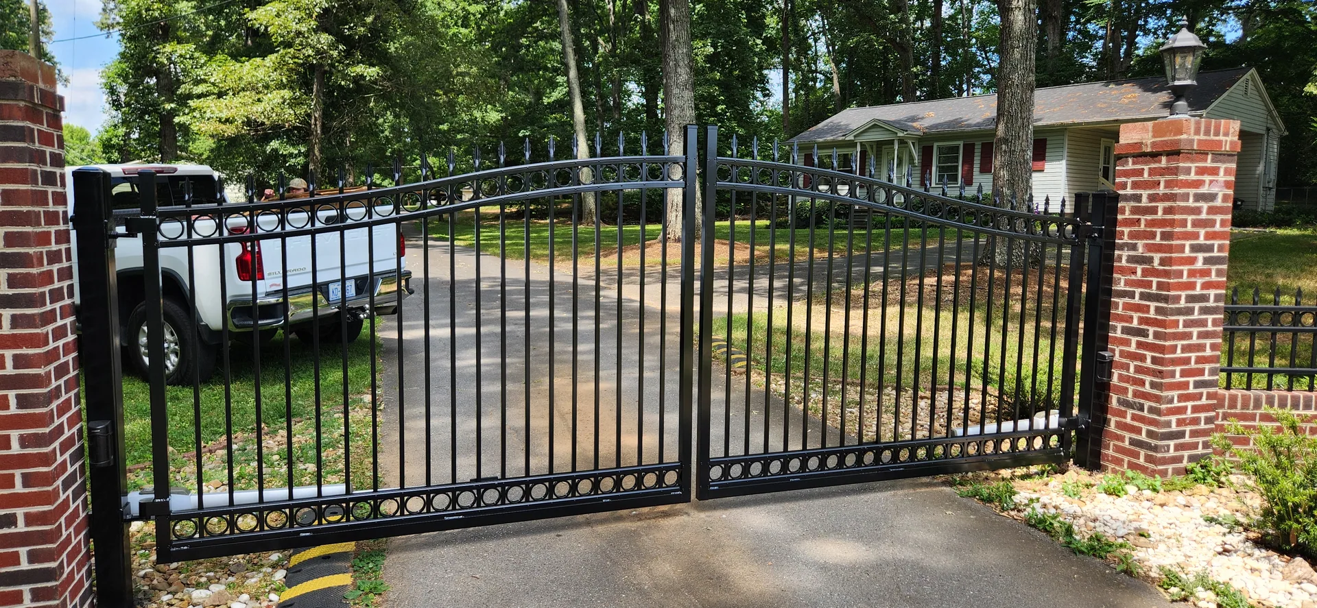 Black aluminum double swing driveway gate red brick pillars gastonia nc