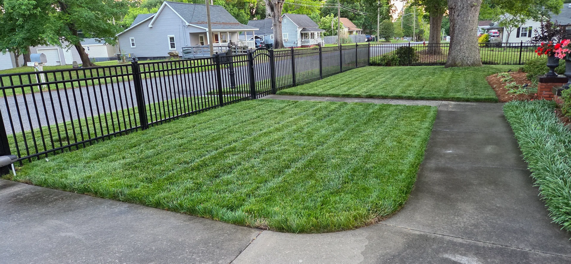 Black aluminum picket fence front yard mowed lawn corner lot gastonia nc