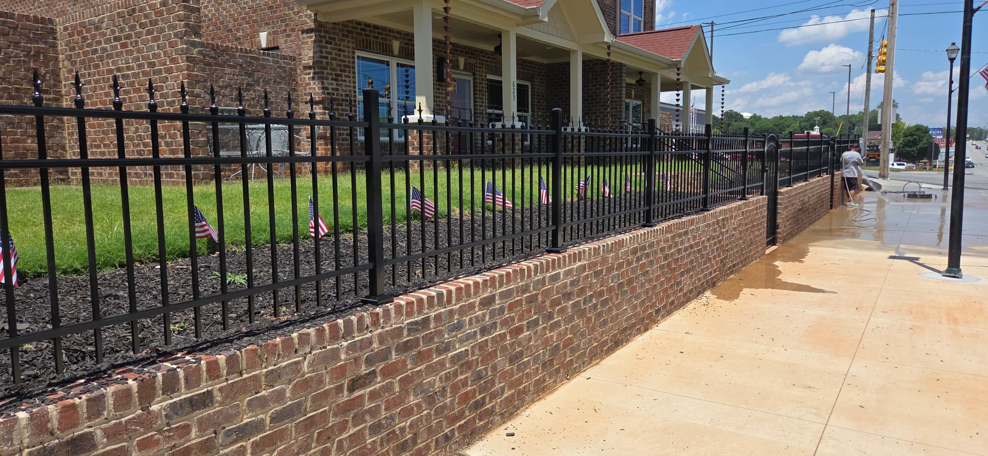 Black aluminum spear top fence brick retaining wall small flags sidewalk gastoni