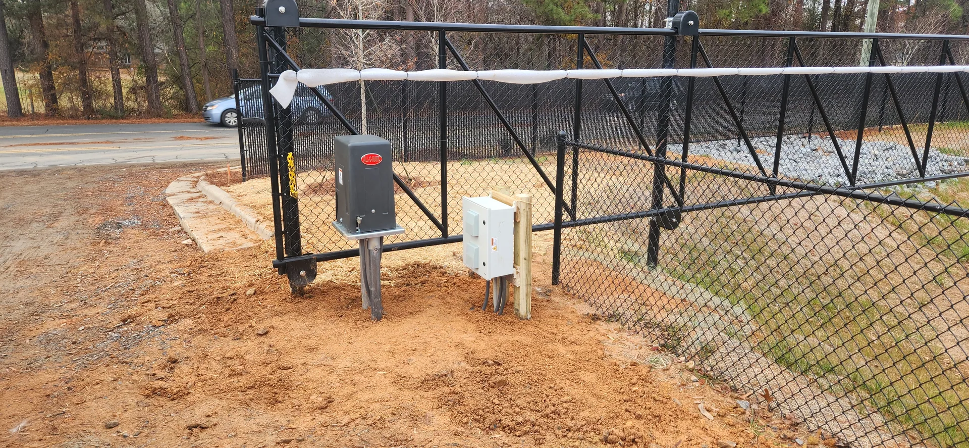 Black chain link cantilever slide gate operator red clay driveway gastonia