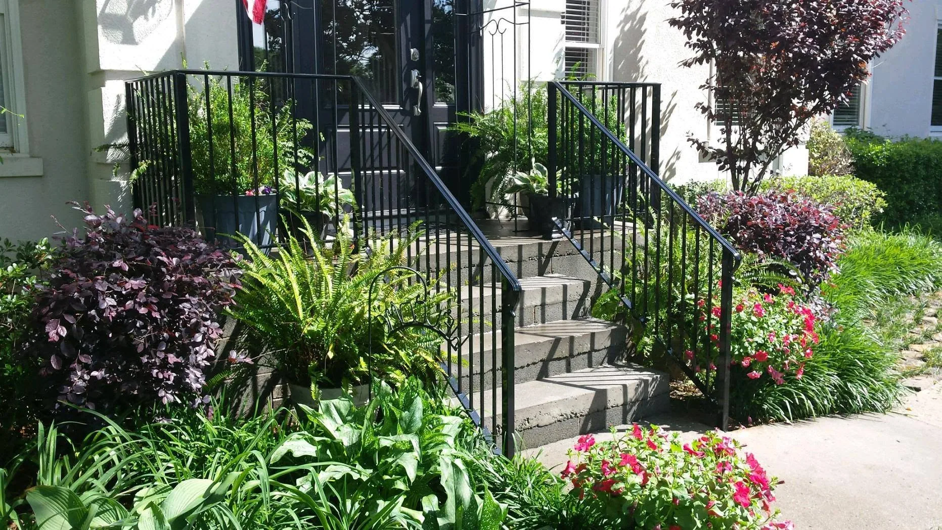 Black wrought iron porch stair railings concrete steps garden gaston county