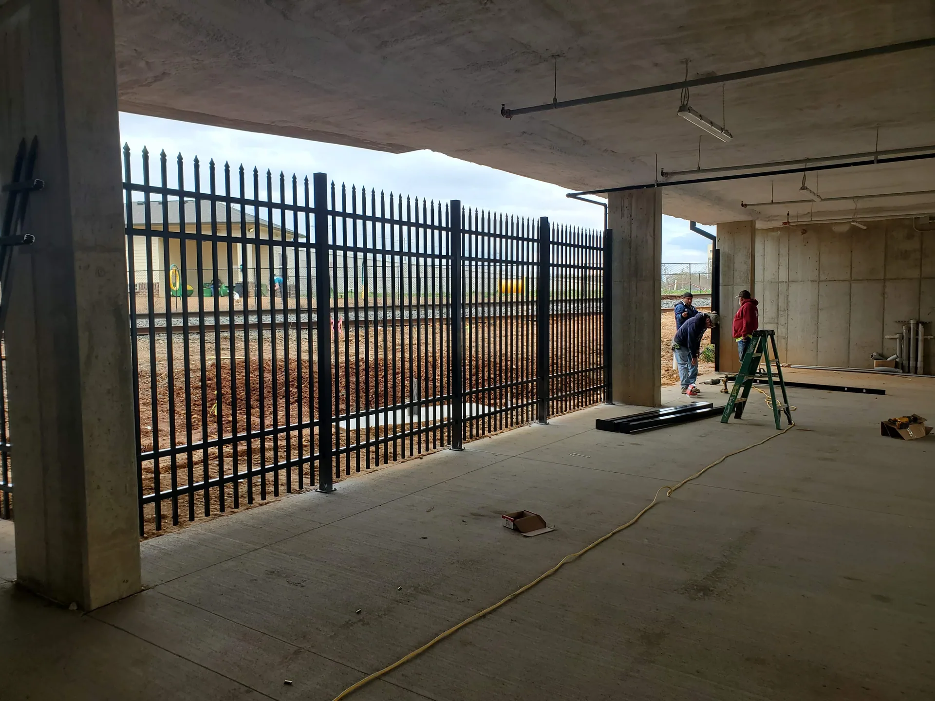 A J & G crew installing black aluminum fence