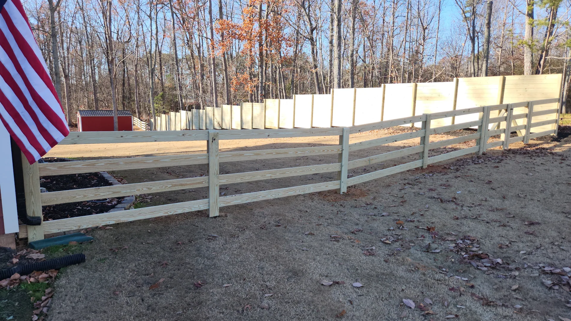 Four rail pressure treated board fence american flag privacy fence backdrop gast