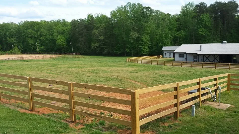Four rail wood horse pasture fence corner barn riding arena gaston county farms