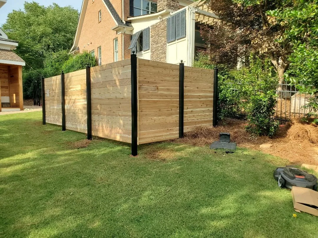 Horizontal cedar board fence black posts robotic mower brick home gastonia