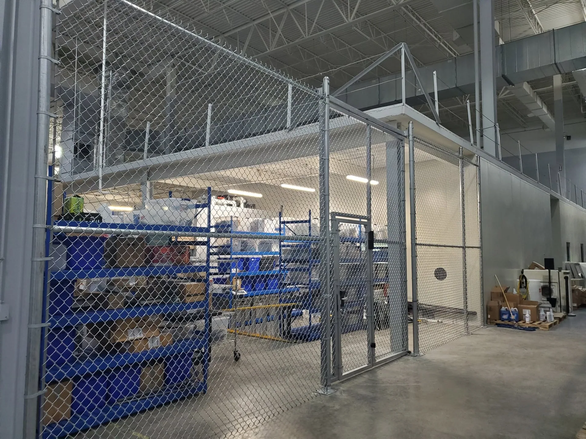 Indoor chain link security cage blue shelving warehouse mezzanine gastonia