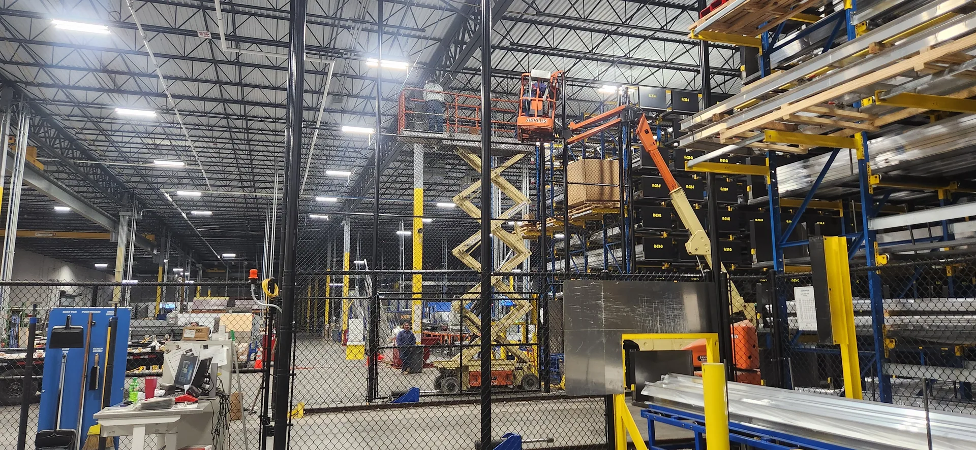Interior warehouse black chain link cage partition lifts pallet racking gaston c