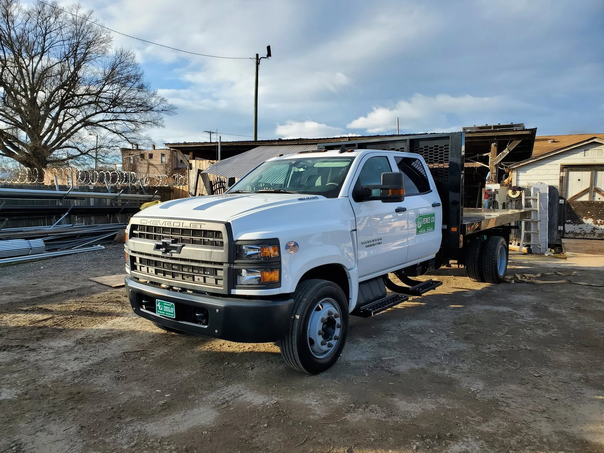 A J & G Fence Company flatbed truck at the material yard