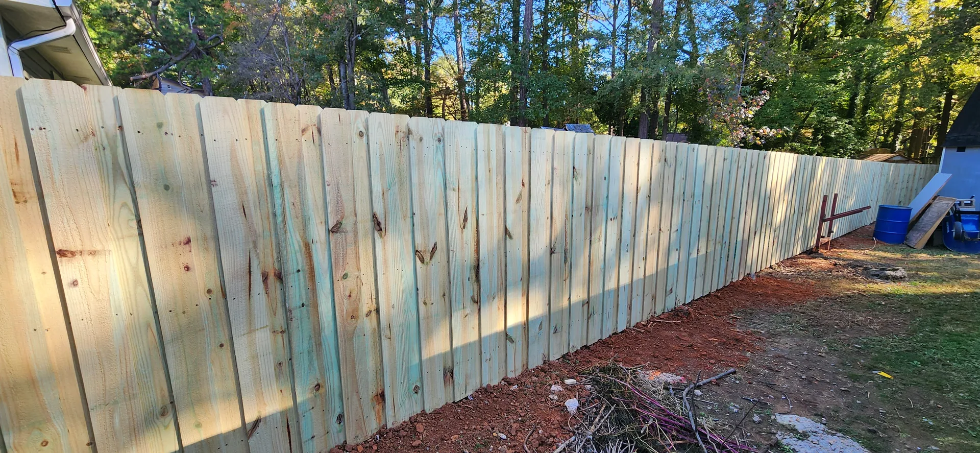 Long pressure treated wood privacy fence run blue barrel yard cramerton nc