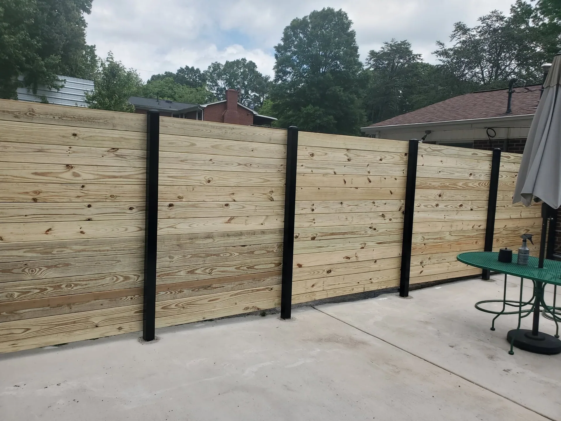New horizontal pine privacy fence concrete patio green table gastonia nc