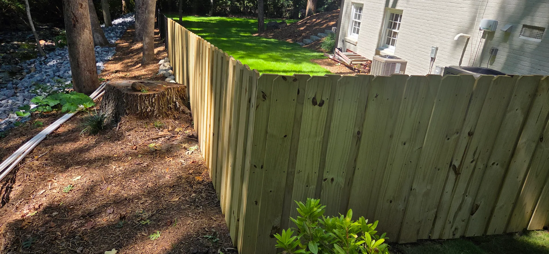 New pressure treated board fence tree stump creek rock hvac gaston county