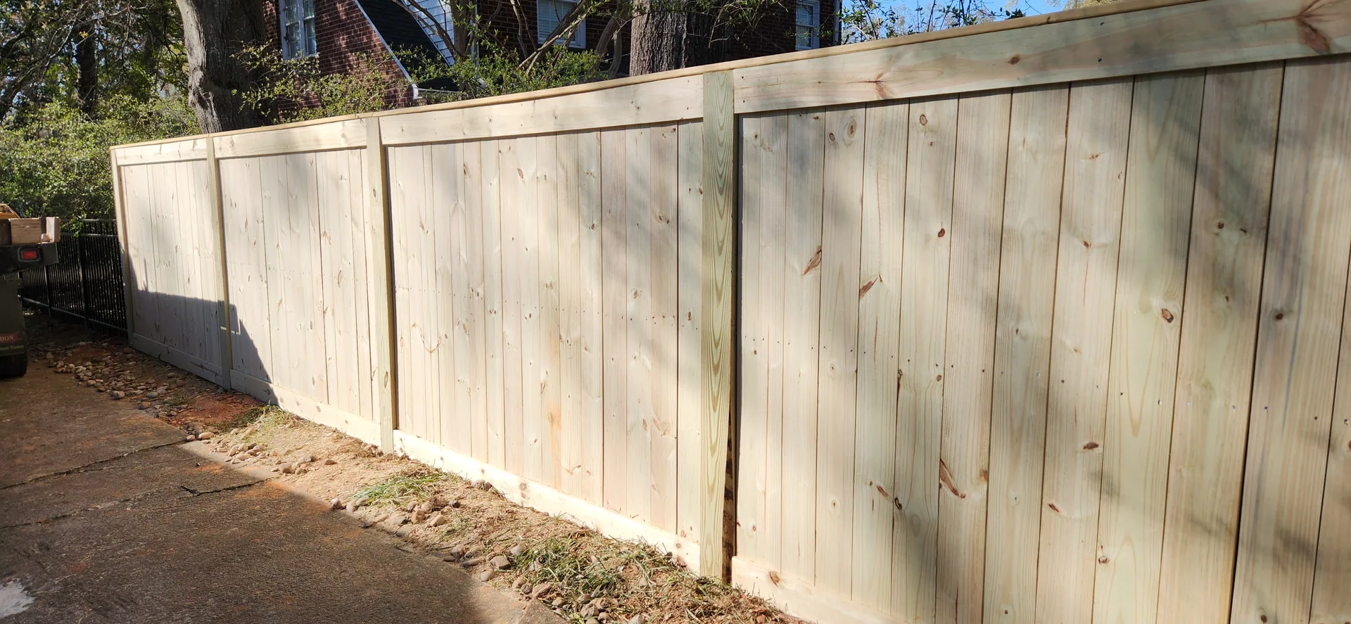 New pressure treated wood privacy fence rock border brick house belmont nc