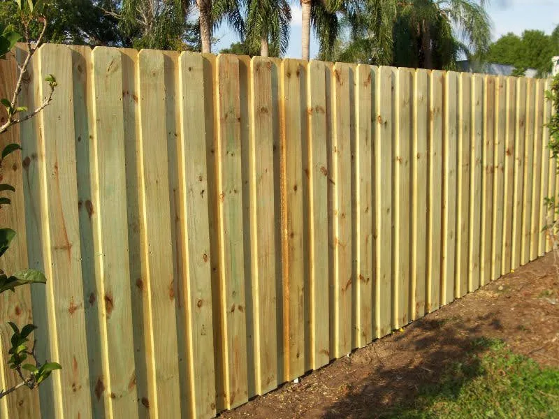 Shadowbox pressure treated wood privacy fence palm trees dirt border gaston coun