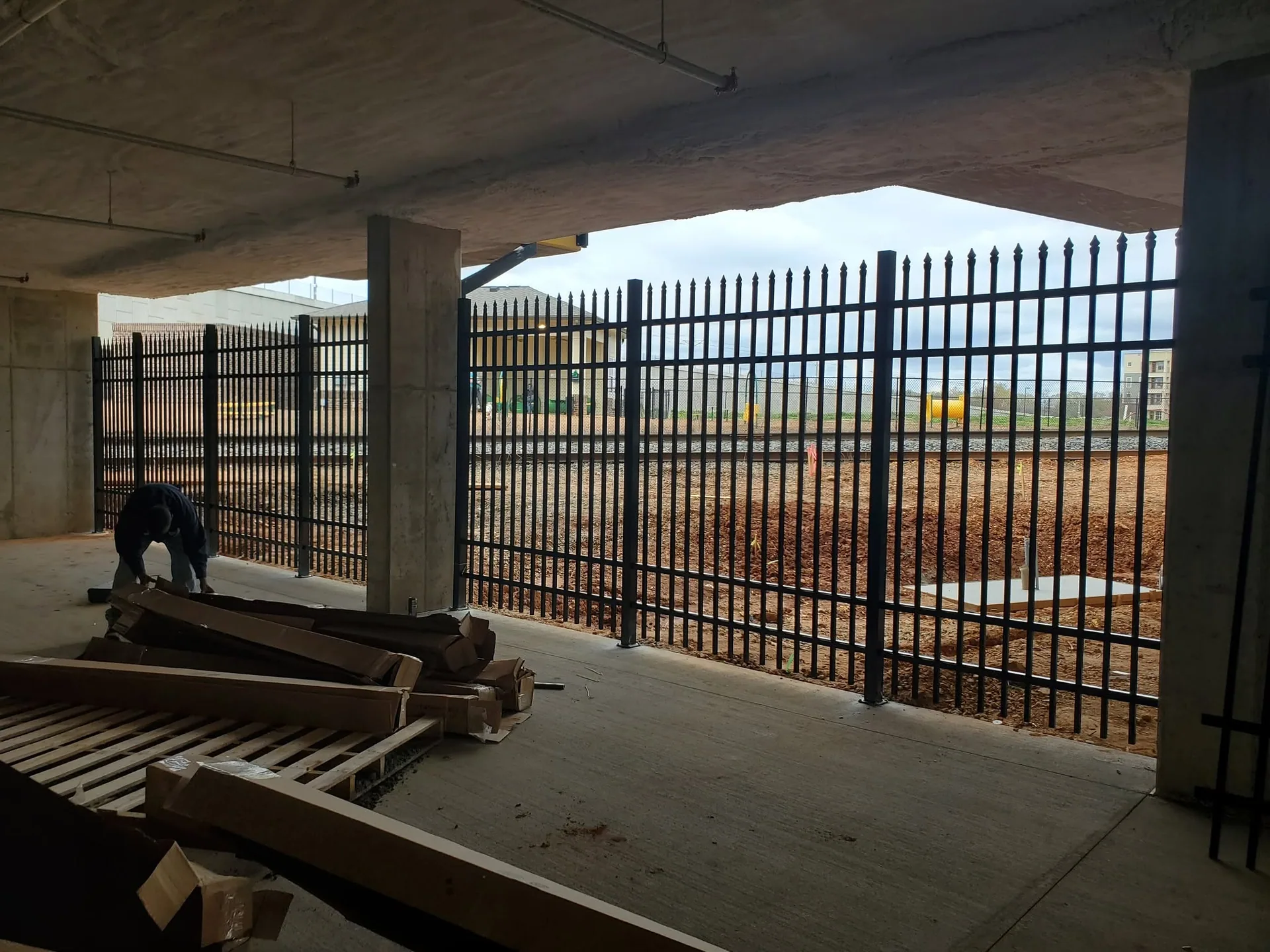 Spear top steel fence parking deck open side railroad view gastonia