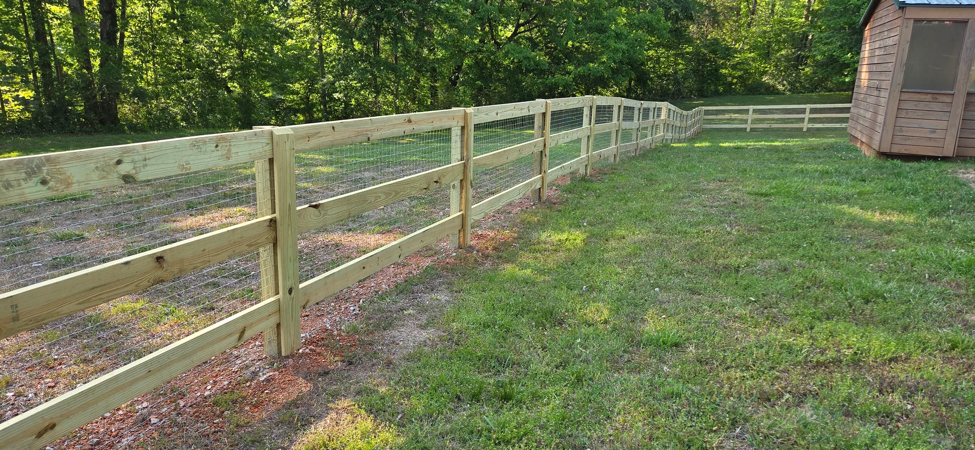 Three rail pressure treated fence wire mesh wood shed grass yard mccadenville nc