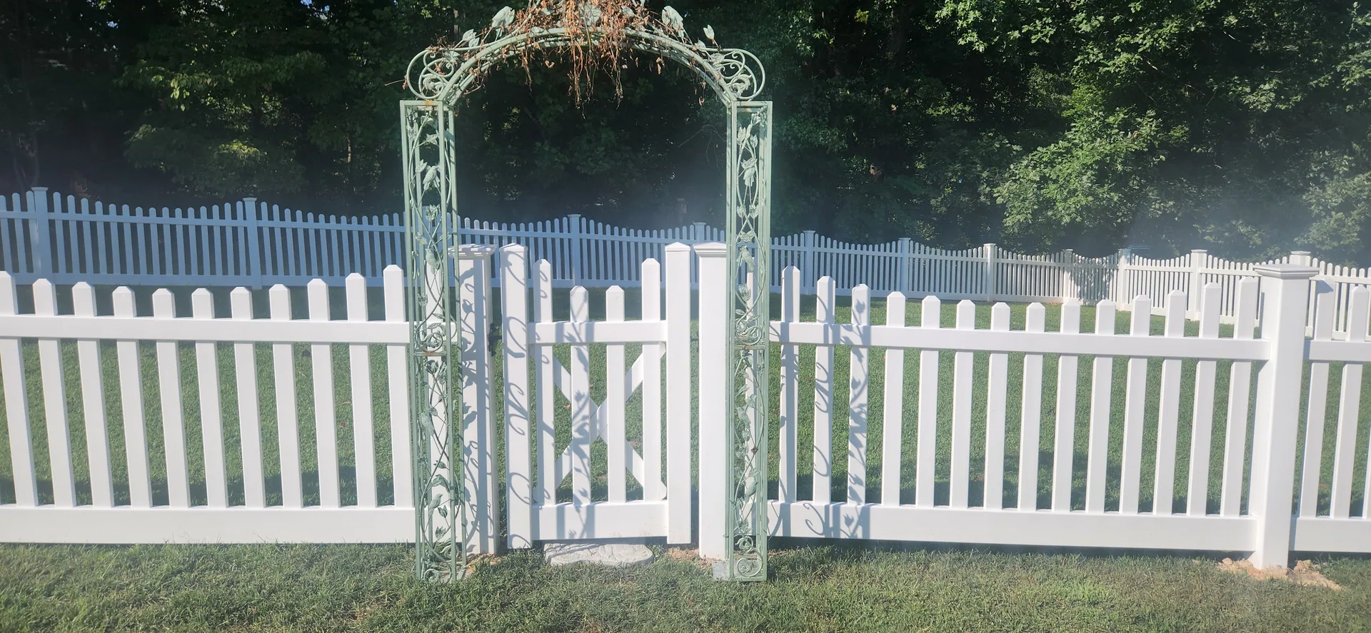Vinyl picket fence walk gate green metal arbor front lawn dallas nc
