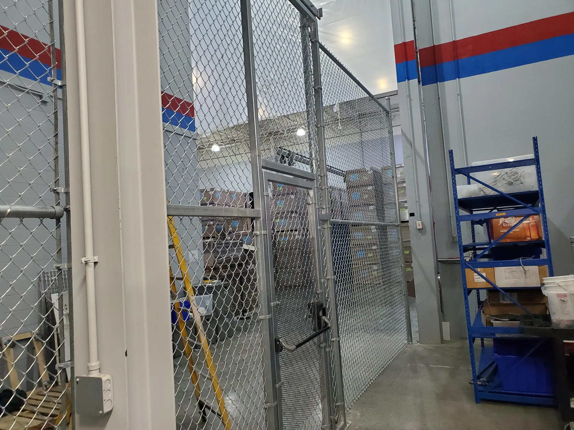 Warehouse chain link security cage walk gate stacked boxes gaston county