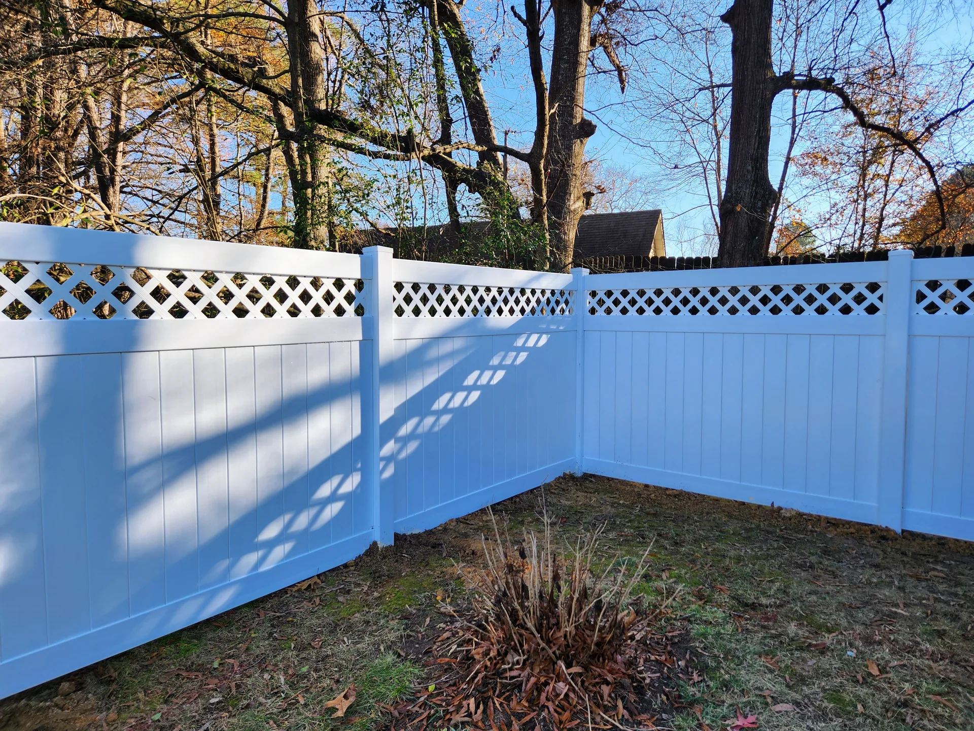 White pvc lattice top privacy fence inside corner backyard dallas nc