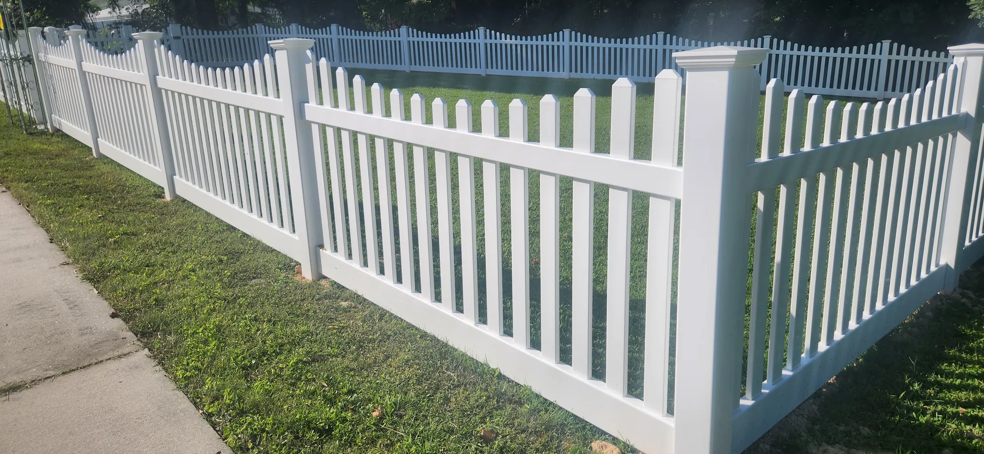 White vinyl picket fence corner sidewalk grass yard gastonia nc