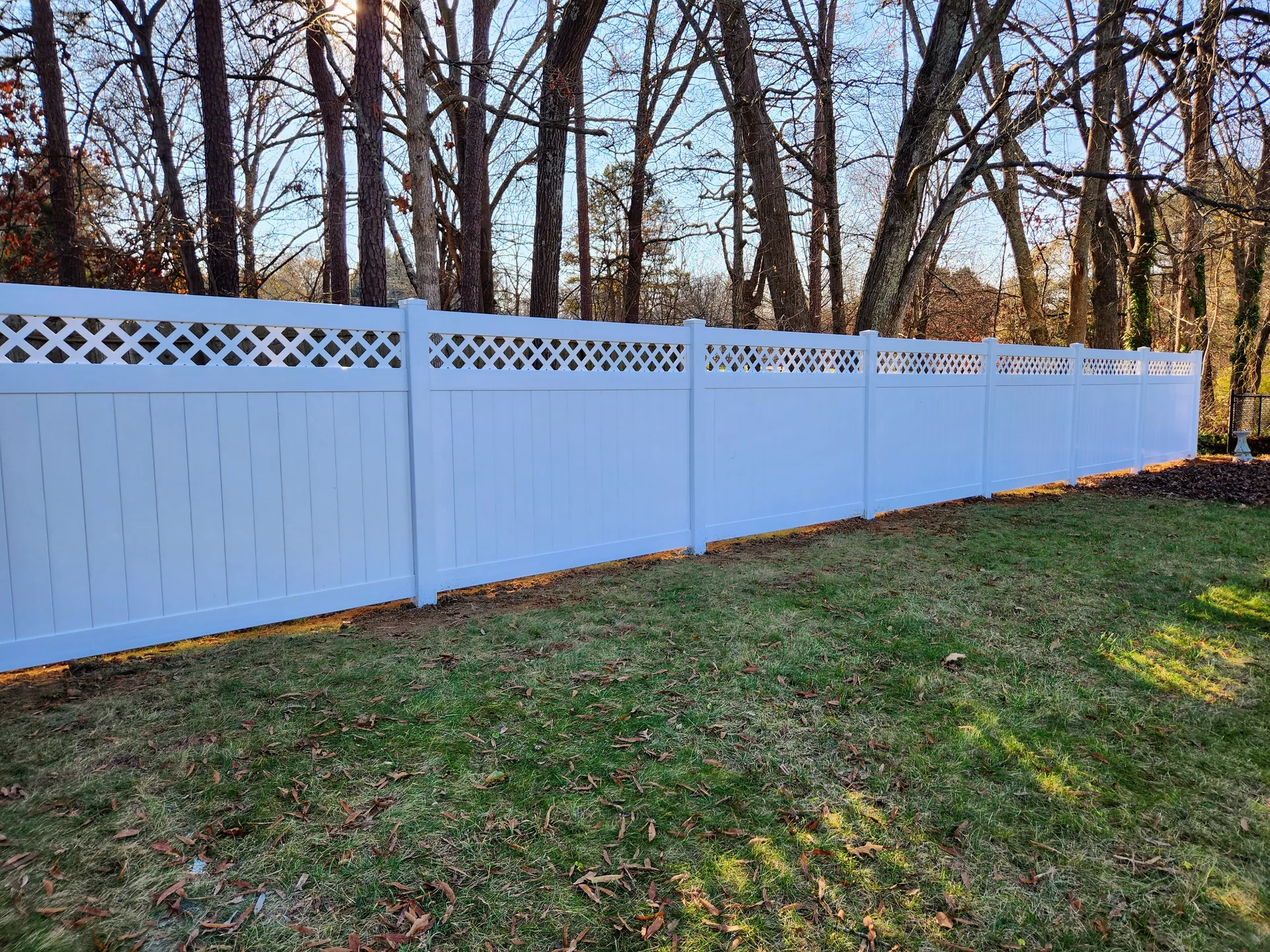 White vinyl privacy fence lattice top sloped yard gaston county